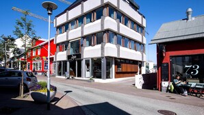 A multi-story building with a modern architectural design, featuring large windows and a prominent entrance. - Svala Downtown Studio Twin beds (Reykjavík)