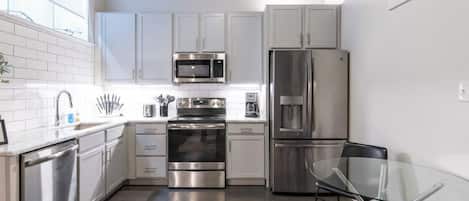 Fridge, coffee/tea maker, cookware/dishes/utensils