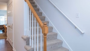 A staircase with wooden balusters and carpeted steps leading to a landing. - This townhouse is a 4 bedroom(s), 3 bathrooms, located in Lexington, KY. (Lexington)