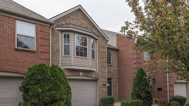 A two-story house with a brick exterior, a bay window, and a garage. - This townhouse is a 4 bedroom(s), 3 bathrooms, located in Lexington, KY. (Lexington)
