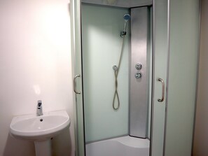 Een douche, een haardroger, pantoffels, zeep