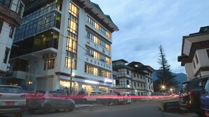 A multi-story building with large windows and a traditional architectural style. - The BD Hotel (Thimphu)