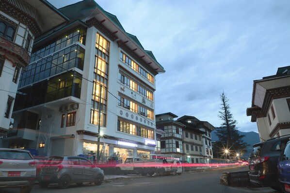 A multi-story building with large windows and a traditional architectural style. - The BD Hotel (Thimphu)