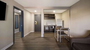 Eine moderne Wohnung mit Küchenzeile, Essbereich und Wohnbereich.