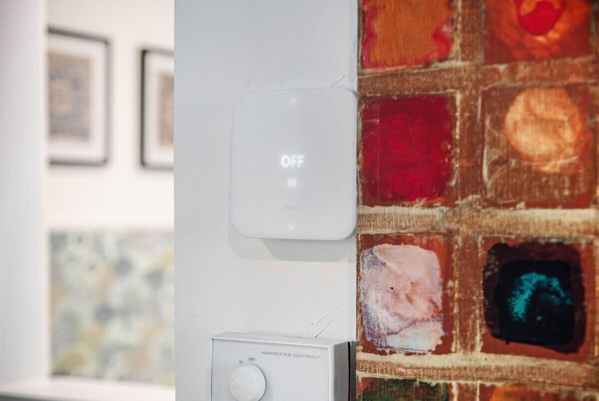 A humidifier control panel and a wall-mounted device, both turned off.