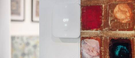 A humidifier control panel and a wall-mounted device, both turned off.