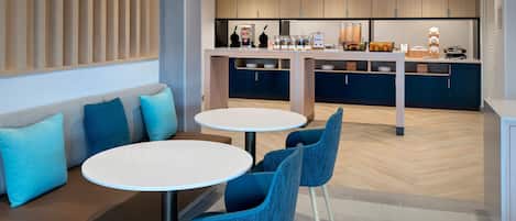 A modern kitchen with wooden cabinets, a central island, and pendant lighting.