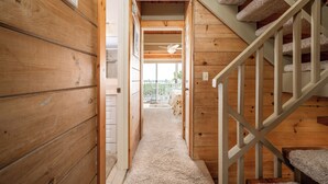 A wooden interior with a staircase and a view to the outside. - Great oceanfront townhome on 67th Street with multiple decks to enjoy the Atlantic Ocean (Ocean City)