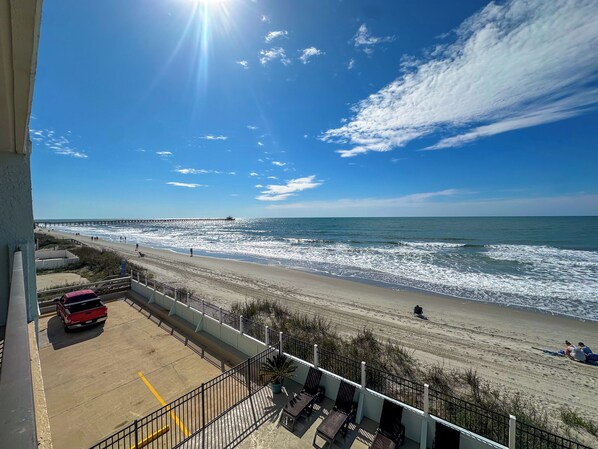 Enjoy the ocean view from this beachfront hotel's balcony with outdoor seating and a secure railing.
