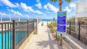 A pathway leading to a beach with a sign indicating Myrtle Beach North Beach and 2902 Walkway. - Shalimar 2B! Oceanfront Bliss! 2BR Condo with Balcony Access from BOTH Bedrooms! (North Myrtle Beach)