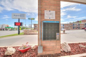 A brick pillar with a sign for 'Sojourn' and a 'SUBWAY' sign in the background.