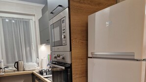A modern kitchen with a built-in microwave, oven, and refrigerator.