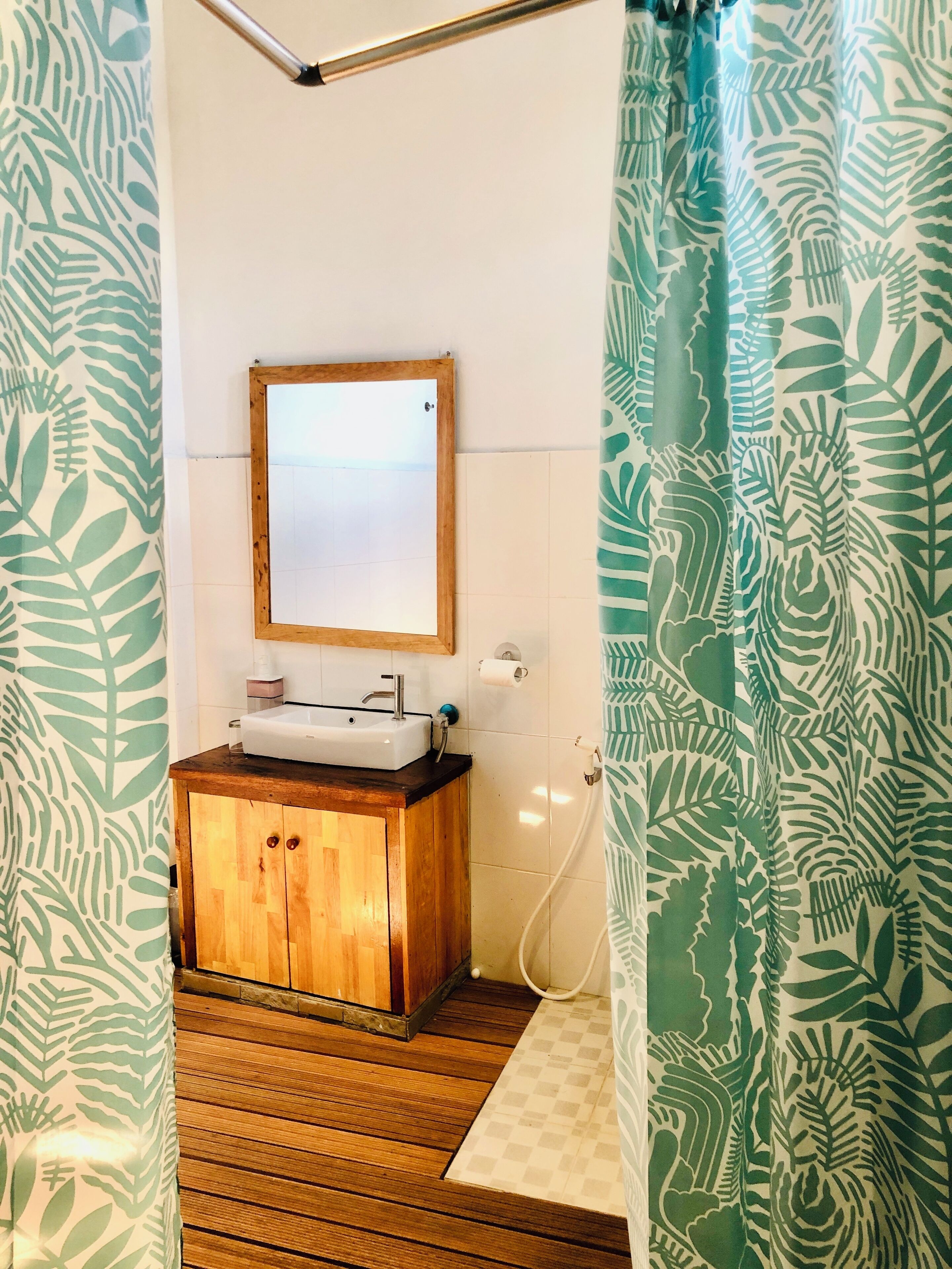 deluxe room | bathroom | shower, slippers, towels, soap