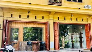 A yellow building with a sign that reads "Stay KULTURA stay cool in comfort". - Stay Kultura (Banda Aceh)