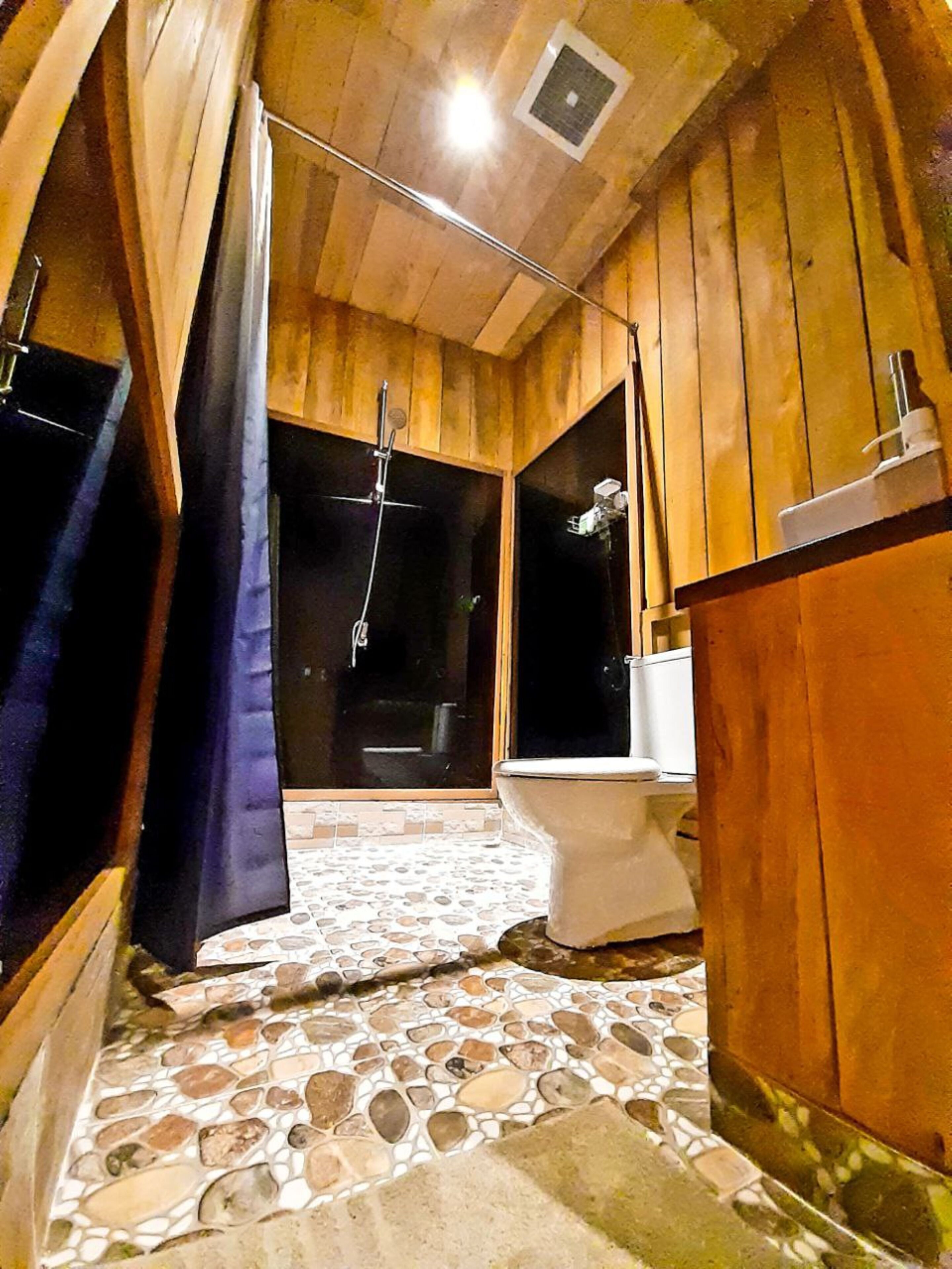 deluxe room | bathroom | shower, slippers, towels, soap