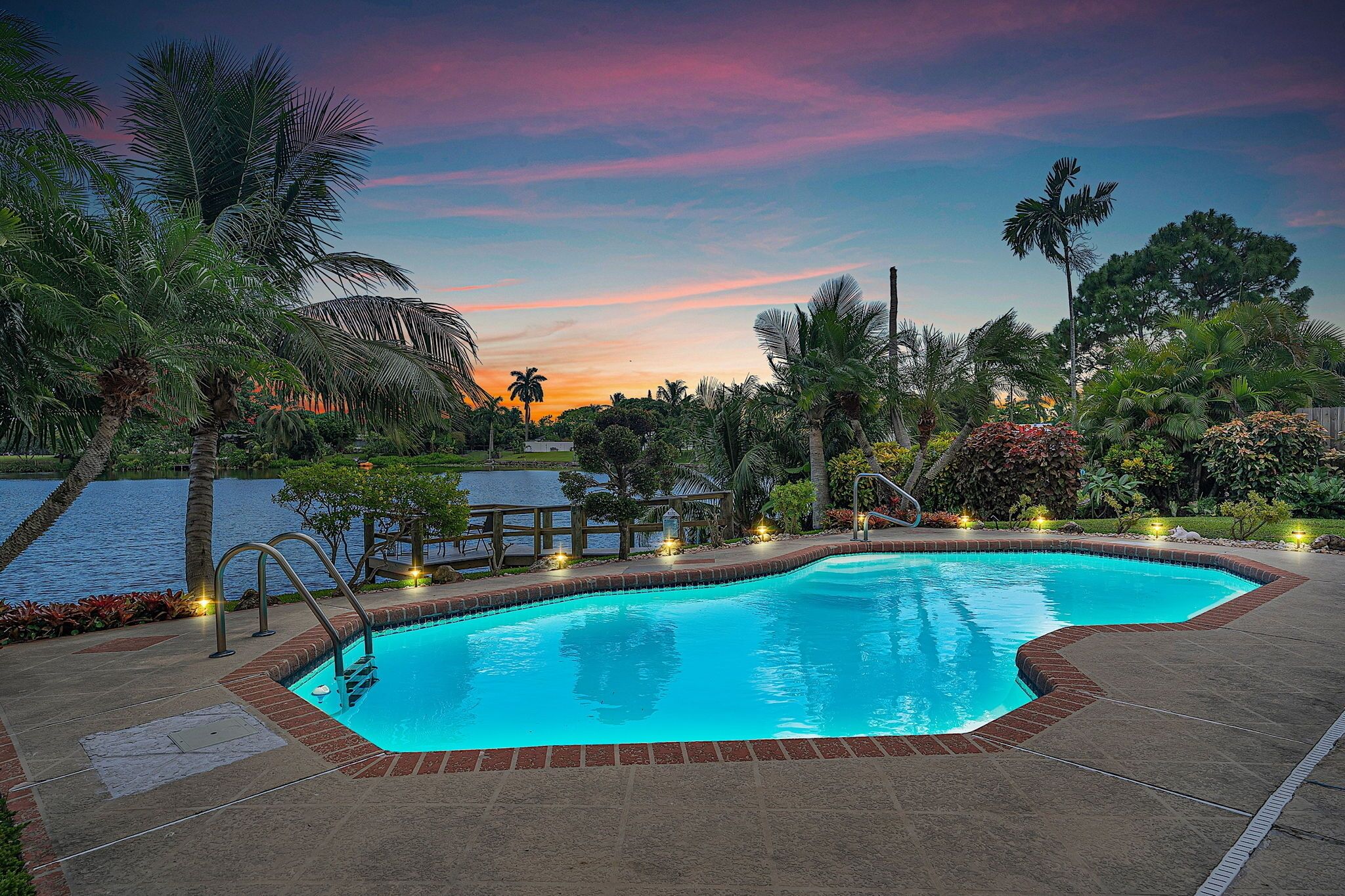 4 bed 3 bath private lakefront home, with heated pool. 3.5 miles to beach.