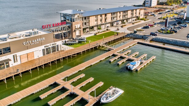 A marina with docked boats, a building labeled "City Harbor," and a view of the surrounding water and hills.