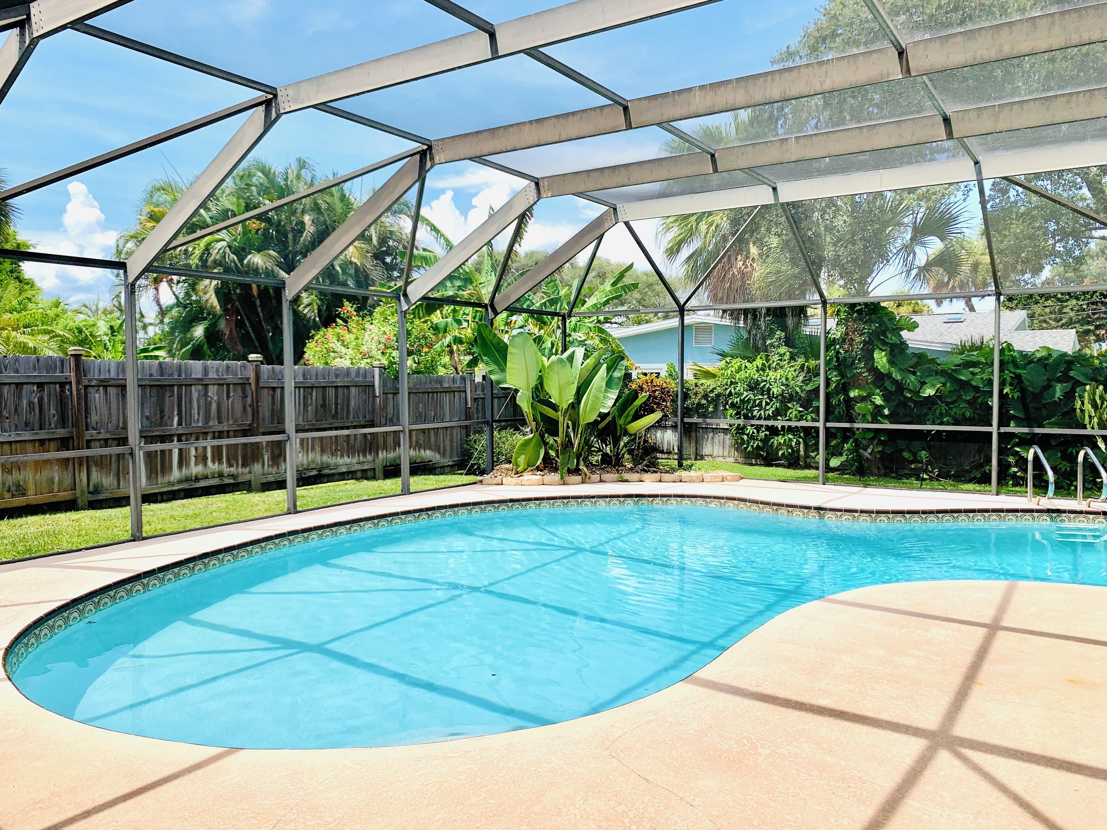 Walk to beach and downtown! Private heated pool with outdoor dining area.