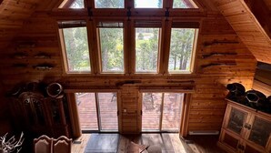 A cabin with a sloped roof, large windows, wooden walls, and a view of the outdoors. - Beautiful log home-dog friendly, creek & mountain views,close to national parks (MAMMOTH CREEK)