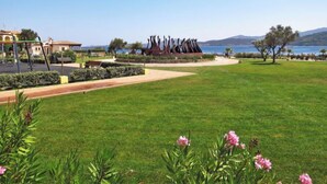 A park with a sculpture, a playground, and a view of the sea. - Donatella by Interhome (Cannigione)