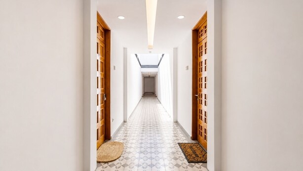 A hallway with patterned flooring, wooden doors, and a skylight. - Cathedral Fantastic View Loft (Heroica Puebla de Zaragoza)