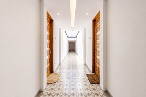 A hallway with patterned flooring, wooden doors, and a skylight. - Cathedral Fantastic View Loft (Heroica Puebla de Zaragoza)