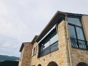 Experience the perfect blend of traditional and contemporary styles in this two-story building with a balcony offering stunning views of the surrounding landscape.
