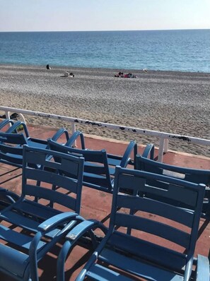 Relax in comfort on the beachside walkway, surrounded by rows of chairs.