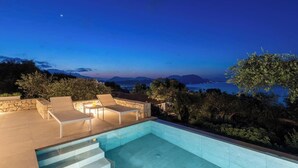 A swimming pool with steps leading into it, surrounded by stone walls and outdoor furniture. - Uranos - Two Bedroom Villa, Sleeps 4 (Corfu)