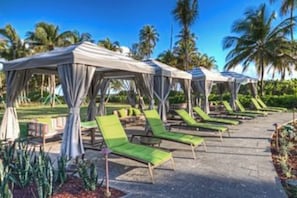 A resort with outdoor seating areas and covered structures.