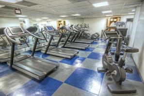 A gym with multiple treadmills and exercise equipment.