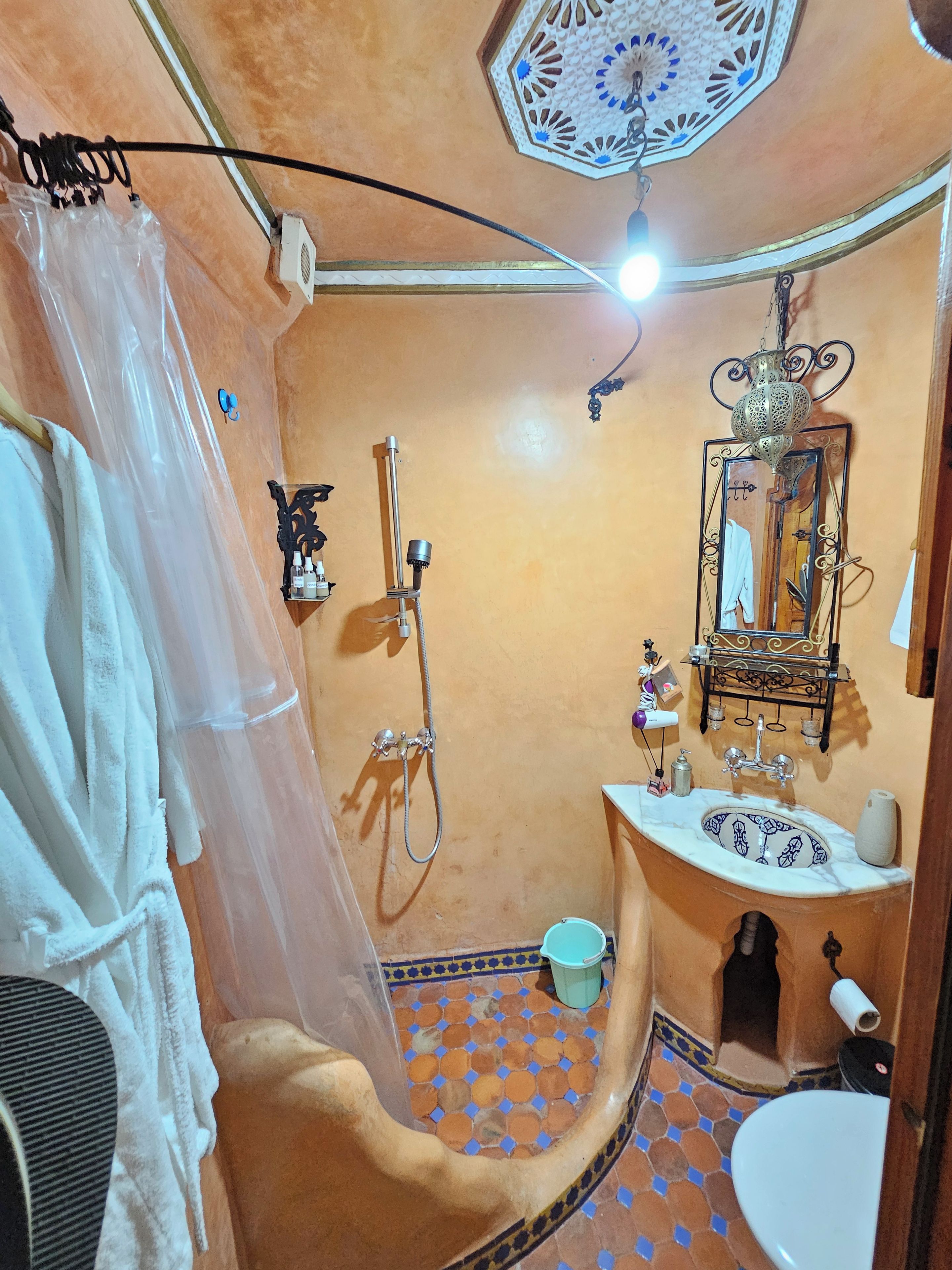 A bathroom with a shower, sink, and toilet.