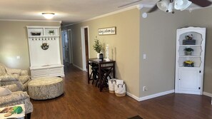 Cozy living area with a dining table, comfortable chairs, and a decorative vase.