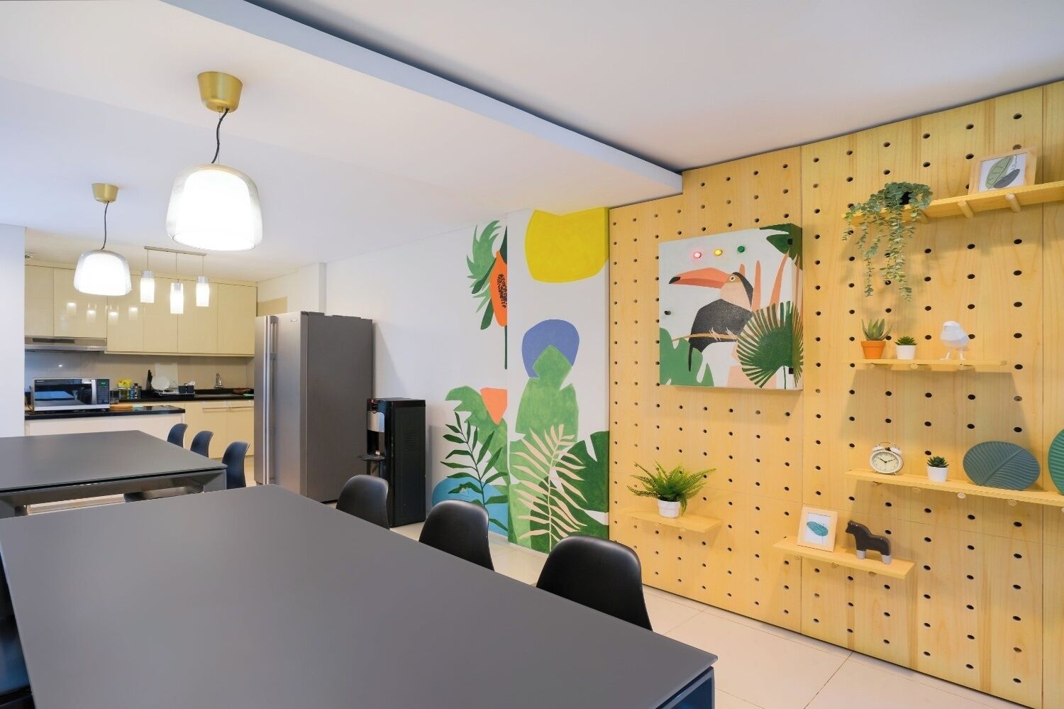 A modern meeting room with a large table, chairs, and a wooden wall with shelves and artwork.