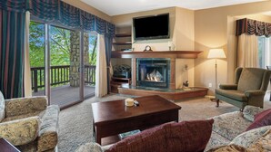 A living room with a fireplace, a television, and a comfortable seating area. - Two Bedroom Villa in a Gorgeous, Gated Community near Silver Dollar City (Reeds Spring)