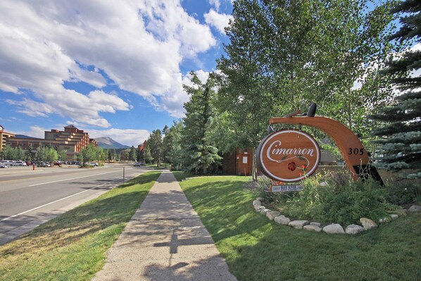 A street sign for 'Cimarron' with a mountain in the background.