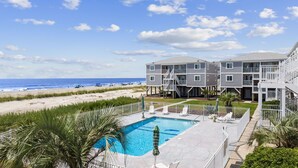 A beachfront hotel with a swimming pool, beach access, and multiple-story buildings. - BEACHFRONT!!! Updated 2 Bedroom 2 Bath  Condo (Ocean Isle Beach)