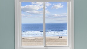 A window with a view of a beach, ocean, and sky. - BEACHFRONT!!! Updated 2 Bedroom 2 Bath  Condo (Ocean Isle Beach)