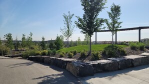 A park with a grassy hill, trees, and a concrete walkway. - Luxurious home away from home with AC in a quiet & Clean Neighborhood just 4 U (Airdrie)