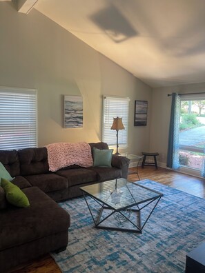 Relax in this stylish living room with a comfortable sofa, coffee table, and artwork on the walls.