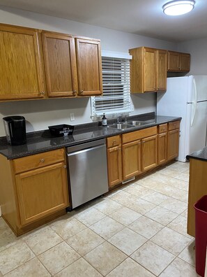 Enjoy cooking in this well-equipped kitchen with a dishwasher, sink, and refrigerator.