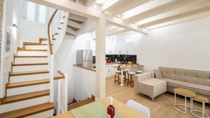 A modern interior with a staircase, kitchen, dining area, and seating space. - Casa di Marina in Corfu (Corfu)