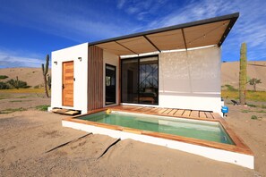 Relax by the spacious outdoor pool, surrounded by serene desert scenery.
