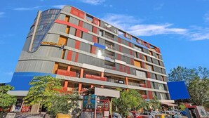 A multi-story hotel with a modern design, featuring balconies and a prominent 'Hotel Planet Villa' sign. - Hotel Planet Villa (Ahmedabad)