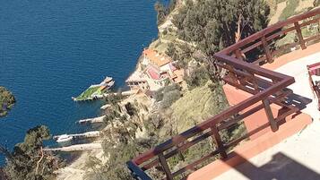 A coastal view with a staircase leading to a terrace overlooking the sea.