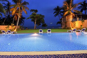 Una piscina al aire libre, tumbonas