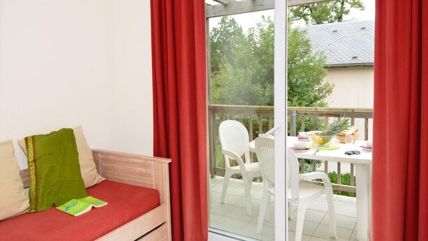 A room with a sliding glass door leading to an outdoor patio area. - Tranquil Escape with Pool (Rignac)