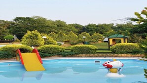 A swimming pool with a slide and a decorative animal figure. - Chalet in Parc de Kievit with Private Garden (Baarle-Nassau)