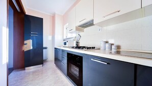 A modern kitchen with a stove, oven, and built-in dishwasher.