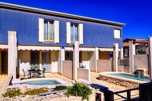 Relax in a spacious outdoor area with a patio, dining set, and small pool.